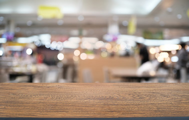 Empty wood table top and blur of night market background/selective focus .For montage product display.