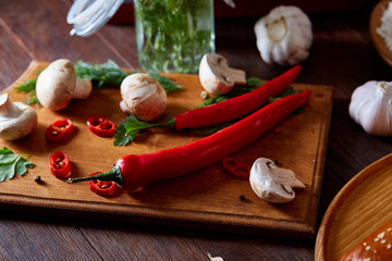 Countryside cuisine still life with pie, vegetable and herbs on cutting board over white background, selective focus.