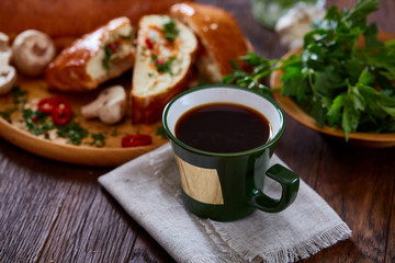 Country side still life with homemade pastries, coffee cup, herbs, vegetables over a vintage background, selective focus