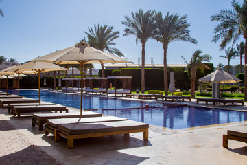 Sharm El Sheikh resort with palm trees and relaxing benches under the clean blue sky