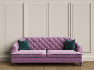 Tufted purple sofa with green pillows in classic interior with copy space