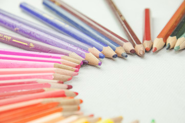 wooden colored pencils on white texture