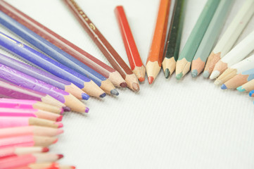 wooden colored pencils on white texture