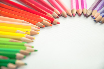 wooden colored pencils on white texture