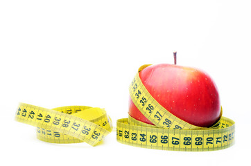 Red apple with a measuring tape on white