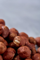 Raw hazelnut on heap isolated on white background, selective focus, shallow depth of field