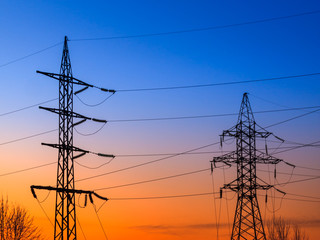 Image of high voltage power line and sky. High-voltage power lines at sunset. Electric transmission towers.