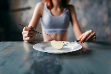 Female person against plate with a slice of apple - obrazy, fototapety, plakaty