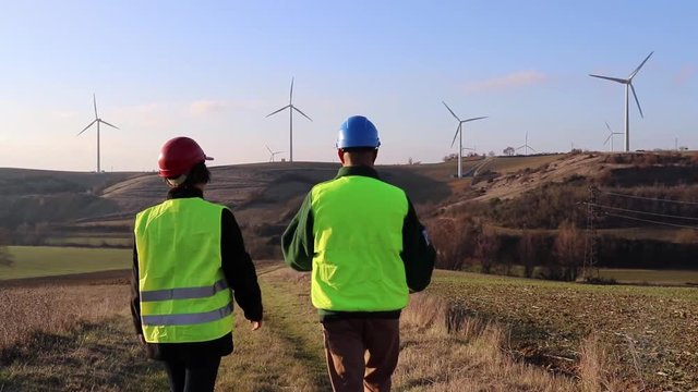 Team of worker male and female. Wind turbines.