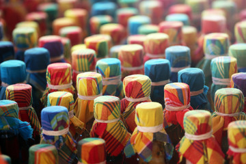 detail of colorful cloth covers on bottles of Ti-Punch made of rum, sugar, fruits and spcies, Guadeloupe, Lesser Antillers, Caribbean