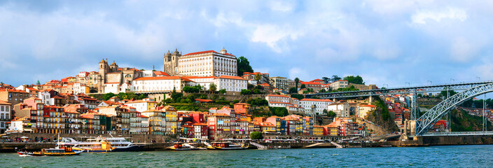 Fototapeta na wymiar Panoramic view of colorful old houses of Porto, Portugal with Luis I Bridge