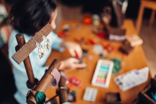 Needlework tools, master at workplace in workshop