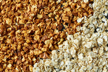 Healthy mix of granola and oatmeal on dark background, top view, close-up, selective focus