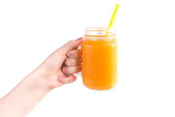 Girl child holding a jar of orange juice, concept of health