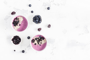 Breakfast with muesli, acai blueberry smoothie, fruits on white background. Healthy food concept....