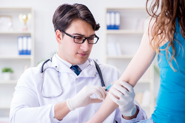 Patient visitng doctor for annual flu shot inoculation for preve