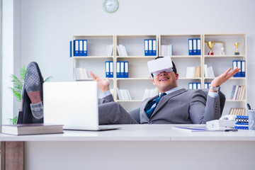 Businessman with virtual reality glasses in modern technology co