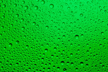 Green water drops on glass. Background.