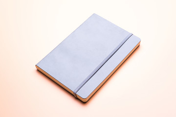 Grey leather notebook isolated on beige background