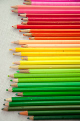 wooden colored pencils on white texture