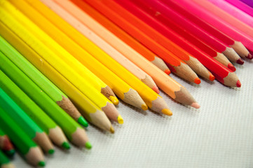wooden colored pencils on white texture