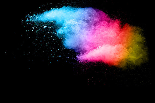 Abstract multi color powder explosion on black background.  Freeze motion of color dust  particles splash. Painted Holi.