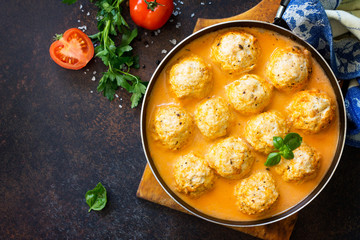 Meat balls turkey in tomato sauce, home cooking on a stone or slate background. Copy space, top view flat lay background.