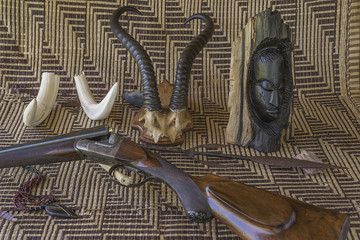 African safari still life with trophies and hunting carbine