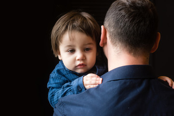 Little boy in arms of father