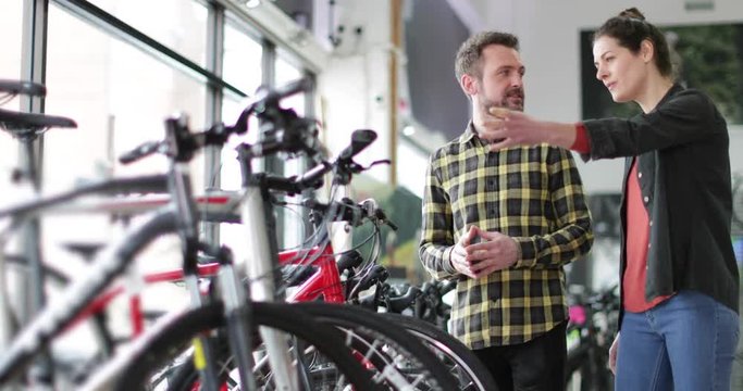 Small business owner serving customer in a bike store