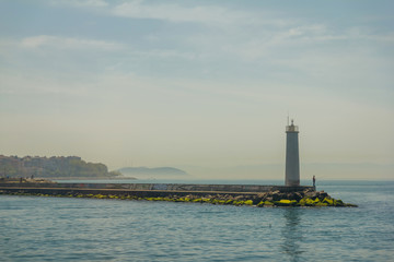 Lighthouse and fisherman