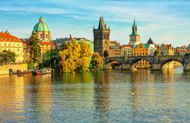 Fototapeta premium Charles Bridge and architecture of the old town in Prague, Czech republic. Evening sunset in the old town of Prague.