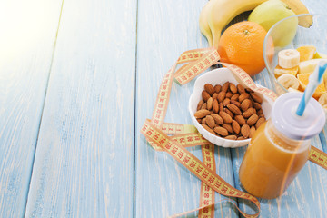 Orange juice in glass, fresh fruits on wooden background. healthy food, diet and detoxification
