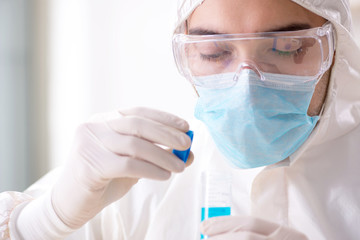 Young chemist student working in lab on chemicals