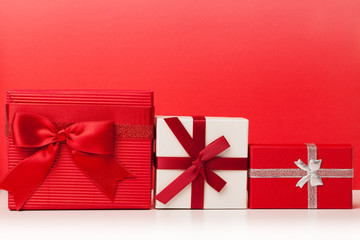 Red and white gift boxes on red background
