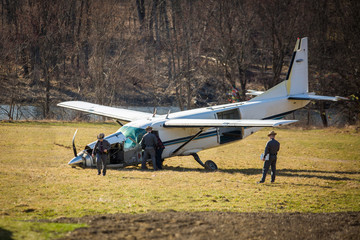 Crashed plane on field with police investigating