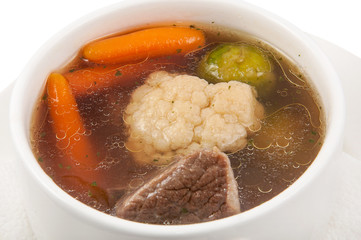 a plate of soup on a white background