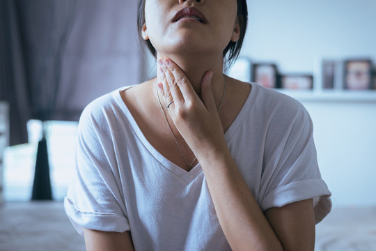 Woman Have A Sore Throat,Female Touching Neck With Hand,Healthcare Concepts