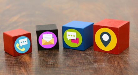 Contact Us Means Icons on wooden blocks