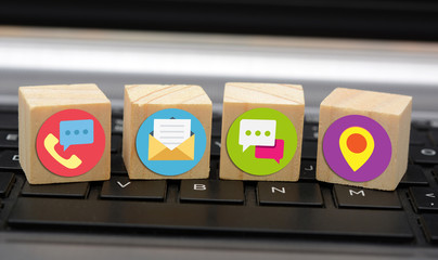 Contact Us Means Icons on wooden blocks on keyboard