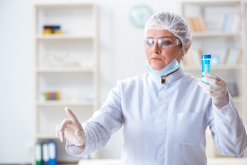 Woman chemist pressing virtual button in lab