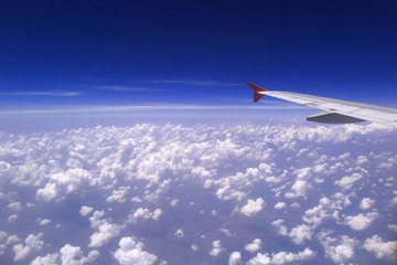 Fototapeta premium Airplane wing with beautiful cloud and blue sky on background, Amazing view from airplane window