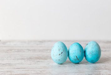 Three Easter blue eggs on a white background. Concept of Easter and spring