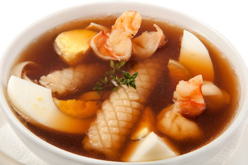 a plate of soup on a white background