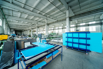 Fototapeta premium Factory for aluminum and PVC windows and doors production. Details industrial equipment.