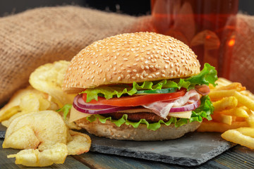 Fast food, homemade burger on a wooden background