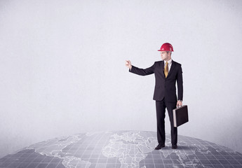 An elegant young male businessman standing on top of the world, pointing up concept with drawn earth map.