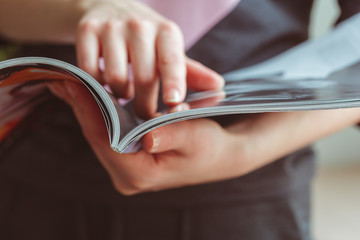 woman reading magazine at home