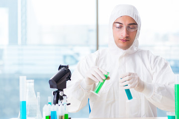 Young chemist student working in lab on chemicals