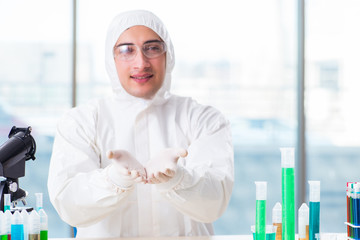 Young chemist student working in lab on chemicals